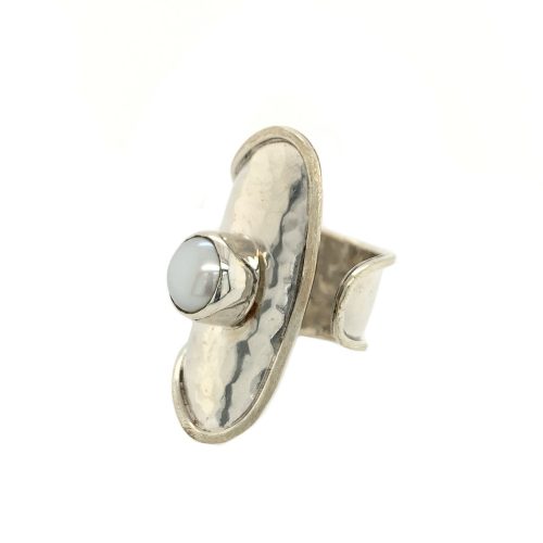 Sterling silver adjustable ring, north to south oval graduating down to open band, bezel set while freshwater pearl in center, hammered finish on silver