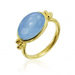 a thin round band gold and oval cabochon aquamarine ring with 3 gold ball accents on each side