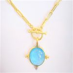 Aquamarine cabochon snap bail pendant in 14k yellow gold with 3 small gold ball accents on each side and 3 diamonds accent at the botton