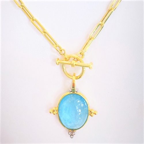 Aquamarine cabochon snap bail pendant in 14k yellow gold with 3 small gold ball accents on each side and 3 diamonds accent at the botton