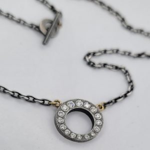 16MM OXIDIZED STERLING SILVER PENDANT SET WITH 0.50CT DIAMONDS ON AN 18” SILVER CHAIN WITH TOGGLE CLOSURE