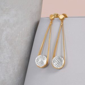 brushed gold post with dangle earrings; a clear faceted crystal globe hangs from a long gold wire swing
