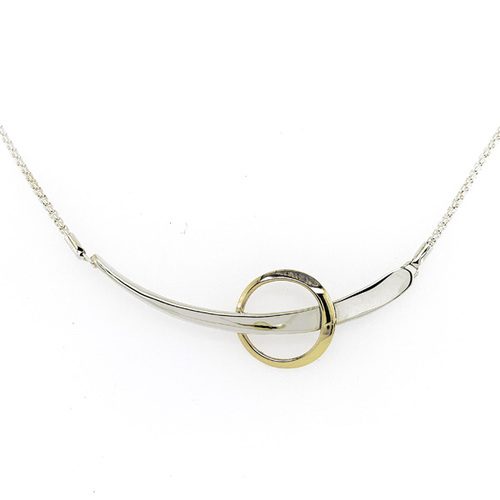 Bi-metal silver and gold necklace; bar of silver with gold circle around the center of it suspended on wither end by a thin silver chain