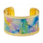 rainbow splash watercolor print on a wide solid cuff bracelet with gold leaf rim and innerside
