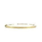 2.5MM Silver hinged bangle featuring an 18k gold push button style clasp and a solid 18k gold sheet top set with 35 white diamonds 0.35ct total combined diamond weight.