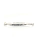 2.5MM. Silver hinged bangle featuring an 18k gold push button style clasp and set with 35 white diamonds 0.35ct total combined diamond weight.